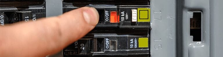 finger pointing at circuit breaker trip