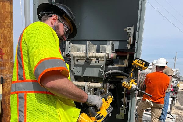 Electrician Cutting Cable Commercial Utility Panel Installation