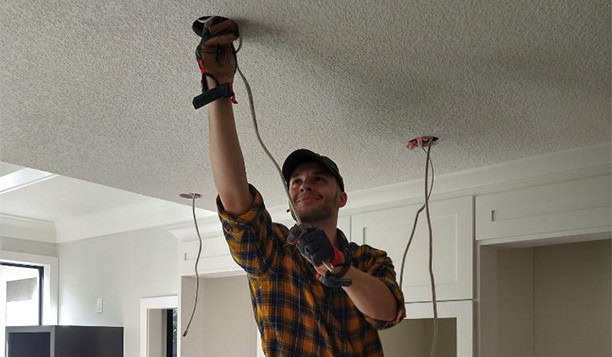 Electrician Installing Recessed Lighting Residential Ceiling
