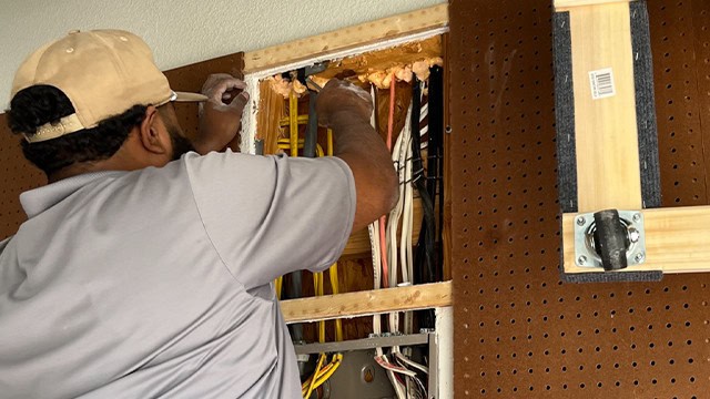 Electrician Installing Residential Wiring Open Wall Cavity