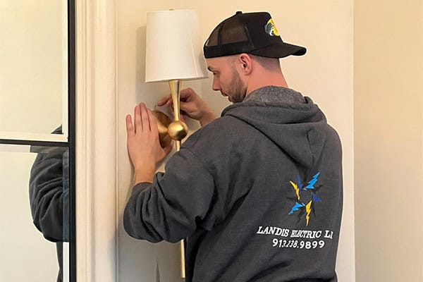 Electrician Installing Wall Light Fixture Residential Interior