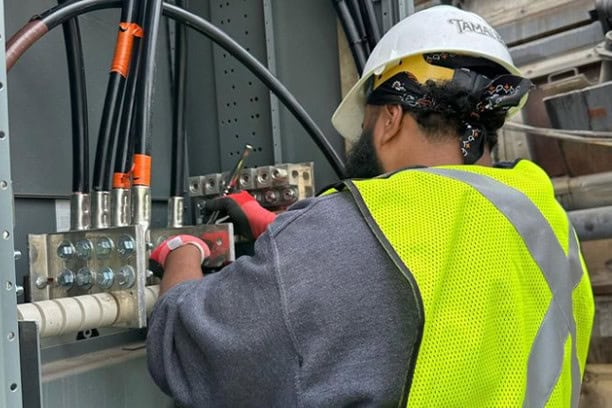 Electrician Working Large Gauge Wiring Commercial Electrical Panel