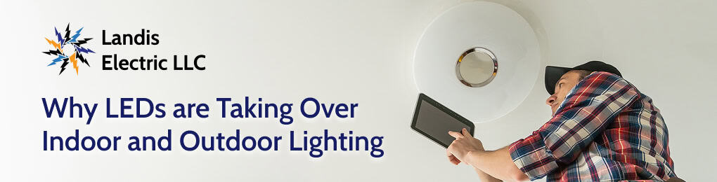 electrician looking at LED light fixture